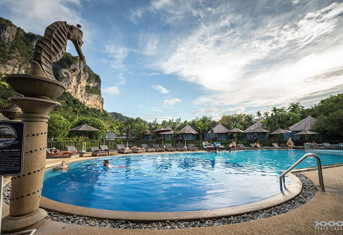Peace Laguna Resort pool in Ao Nang, Krabi. Best gay-friendly hotel with seahorse statue, bungalows, and mountain views. Cheap & best option.