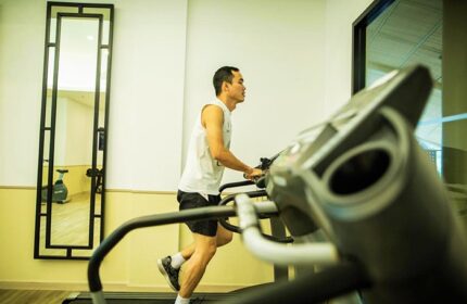 Holiday Inn Express Krabi Ao Nang Beach gym: Man on treadmill. Great for a cheap gay honeymoon hotel stay in Krabi. Fitness center.