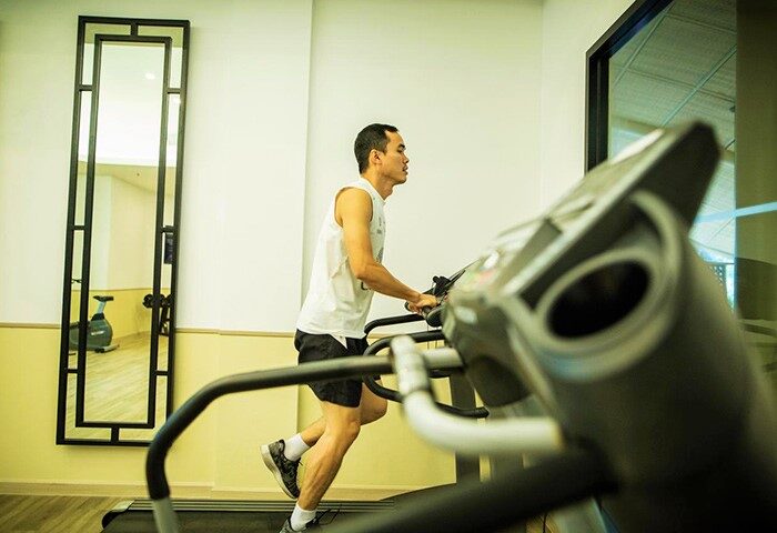 Holiday Inn Express Krabi Ao Nang Beach gym: Man on treadmill. Great for a cheap gay honeymoon hotel stay in Krabi. Fitness center.