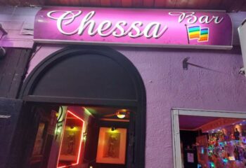 Chessa Bar entrance in Torremolinos, Spain. Gay bar with rainbow flag. Nightlife destination for gay men, part of gay travel advice.