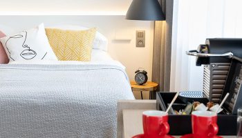 Mosaic House Design Hotel, Prague: Chic room detail. Gay-friendly hotel with modern design, bed, coffee machine, and red cups. Old Town stay.