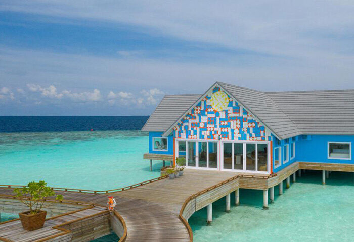 The Standard, Huruvalhi Maldives: Chic, fun design at this gay-friendly hotel. Overwater bungalow with blue accents and a wooden walkway.