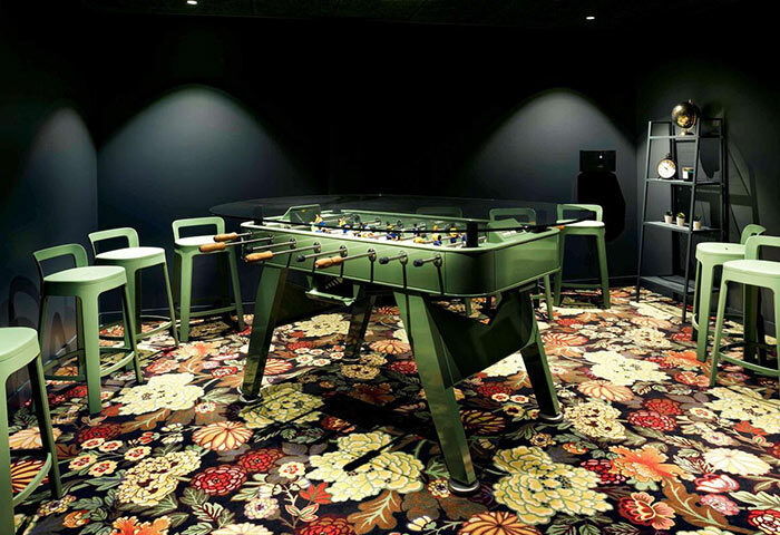 Fun design at Mercure Paris Centre Tour Eiffel hotel, near gay bars. Foosball table, stools, floral carpet. Chic, fun Paris gay travel.