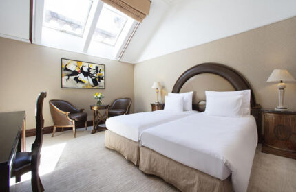 NH Collection Carlo IV Prague room. Chic, stylish design in Old Town. Gay-friendly hotel with twin beds, skylight, and modern art.