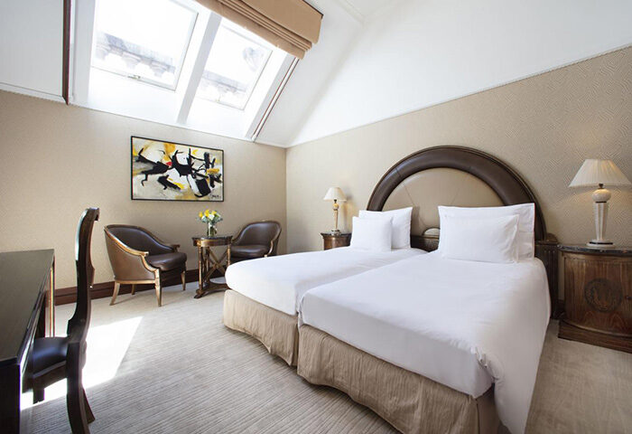 NH Collection Carlo IV Prague room. Chic, stylish design in Old Town. Gay-friendly hotel with twin beds, skylight, and modern art.