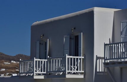 Hermes Mykonos Hotel: Chic white building with balconies in Mykonos Town's gayborhood. Unique design for gay travelers.
