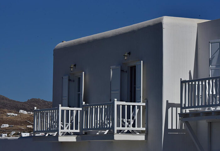 Hermes Mykonos Hotel: Chic white building with balconies in Mykonos Town's gayborhood. Unique design for gay travelers.