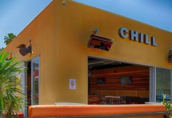 Chill Bar location. Exterior view of the Chill Bar, a gay-friendly travel destination. The building is yellow with the name Chill in silver letters.