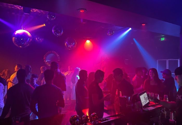 Gay Chill Bar party scene. Men gather under disco balls and colorful lights. Nightlife at its finest. Gay travel.