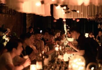 Chin Chin Bar, Ho Chi Minh City. Bartender serving drinks at a busy, trendy gay bar. People are enjoying drinks at the bar. Nightlife.