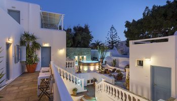 Carbonaki Hotel in Mykonos Chora. Central location near gay bars and gay cruise spots. Whitewashed buildings with a jacuzzi at dusk.