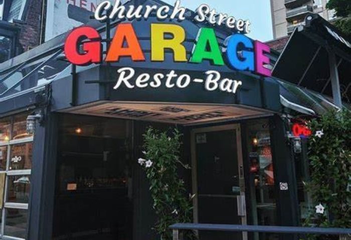 Church Street Garage Resto-Bar in Toronto. Popular gay bar with rainbow-colored sign. A must-visit destination for gay travelers.
