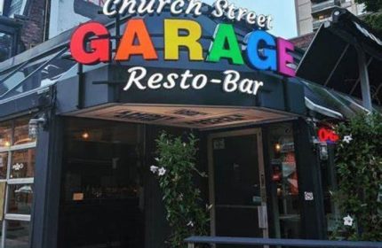 Church Street Garage Resto-Bar in Toronto. Popular gay bar with rainbow-colored sign. A must-visit destination for gay travelers.