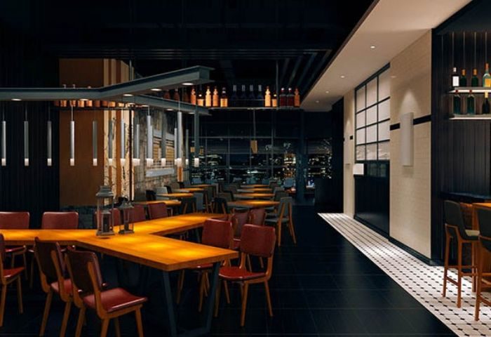 Interior of Church Street Garage Resto-Bar in Toronto. Tables, chairs, and bar area visible. Gay travel destination.