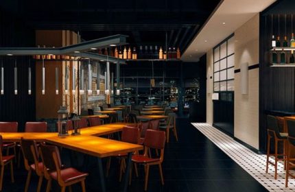 Interior of Church Street Garage Resto-Bar in Toronto. Tables, chairs, and bar area visible. Gay travel destination.