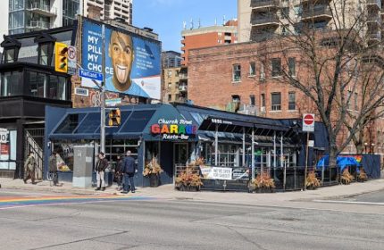Church Street Garage Resto-Bar in Toronto, a popular gay-friendly spot. Rainbow crosswalk in front. Great for gay travel advice!