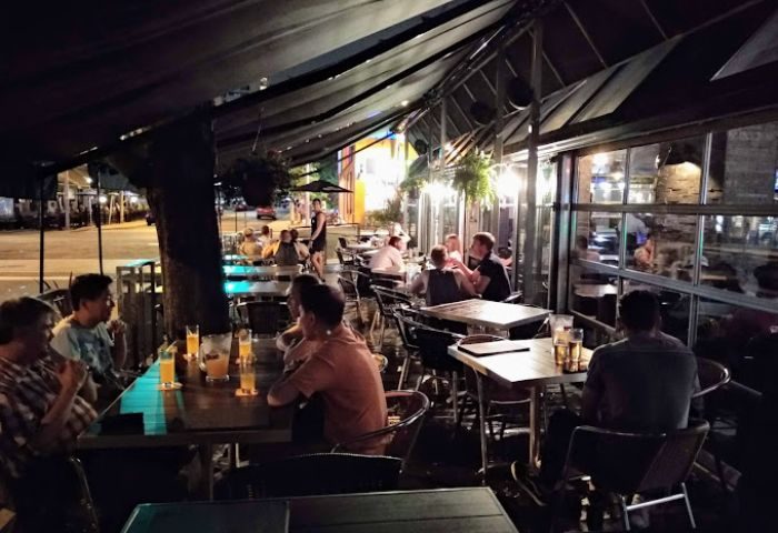 Church Street Garage Resto-Bar in Toronto: Outdoor patio view at night, people dining. A popular gay bar and restaurant in the Church-Wellesley Village.