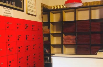 Interior of Cihangir Sauna, Istanbul. Red lockers, shelves with towels. Travel advice for gay men visiting Istanbul's gay sauna scene.