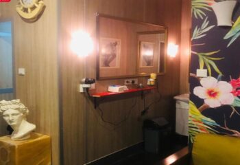 Cihangir Sauna Istanbul interior. Mirror, bust, and floral wallpaper. Gay travel advice, Turkish bath, male grooming, and relaxation.