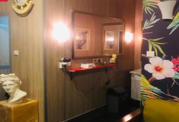 Cihangir Sauna Istanbul interior. Mirror, bust, and floral wallpaper. Gay travel advice, Turkish bath, male grooming, and relaxation.