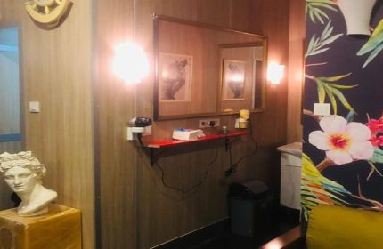 Cihangir Sauna Istanbul interior. Mirror, bust, and floral wallpaper. Gay travel advice, Turkish bath, male grooming, and relaxation.