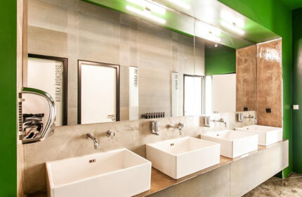 Czech Inn, clean rooms in Prague's gayborhood. Modern bathroom with square sinks, large mirror, and green accents. Gay hotels in Vinohrady.