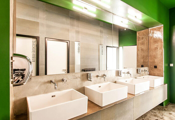Czech Inn, clean rooms in Prague's gayborhood. Modern bathroom with square sinks, large mirror, and green accents. Gay hotels in Vinohrady.