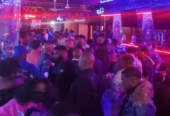 Crowded party at Club Escape in Chicago. Gay men enjoy drag shows and nightlife in a lively, colorful atmosphere. Gay travel advice.