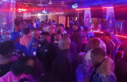 Crowded party at Club Escape in Chicago. Gay men enjoy drag shows and nightlife in a lively, colorful atmosphere. Gay travel advice.
