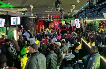 Inside Club Escape: A lively drag show party in Chicago. People gather, enjoying the vibrant atmosphere of this gay-friendly venue.