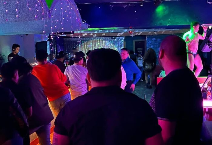 Inside Club OMG Gay Bar in San Francisco, crowd watches a dancer on stage. Nightlife scene, gay travel destination.