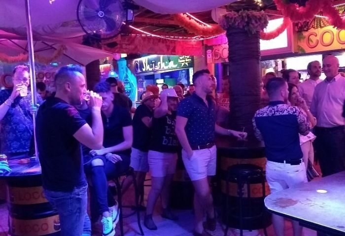 Coco Loco Gay Bar in Gran Canaria. Interior view of a lively gay bar with men socializing, drinking, and enjoying the atmosphere.