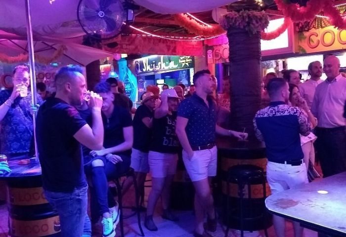 Coco Loco Gay Bar in Gran Canaria. Interior view of a lively gay bar with men socializing, drinking, and enjoying the atmosphere.