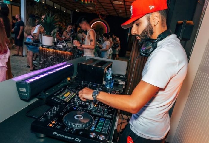DJ at Colombian Hotel Sydney. Gay nightlife scene with music, lights, and a vibrant atmosphere. Gay travel in Sydney, Australia.