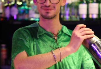 Gay bar in Rome: Bartender at Coming Out bar, Rome, makes a cocktail. Rome's gay scene offers a vibrant nightlife for gay men travelers.