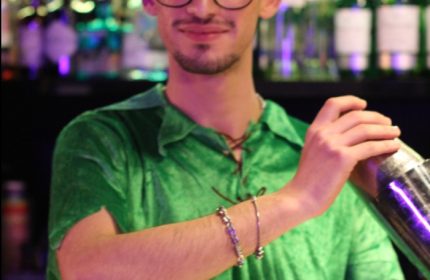 Gay bar in Rome: Bartender at Coming Out bar, Rome, makes a cocktail. Rome's gay scene offers a vibrant nightlife for gay men travelers.