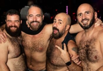 Four shirtless, bearded men pose together in Rome, Italy. Gay travel in Rome, Italy. Gay bears. Rome nightlife.