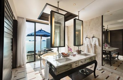 Luxury bathroom at Conrad Koh Samui, a gay-friendly resort. Ocean view, bathtub, and double vanity. Ideal for gay men's travel.
