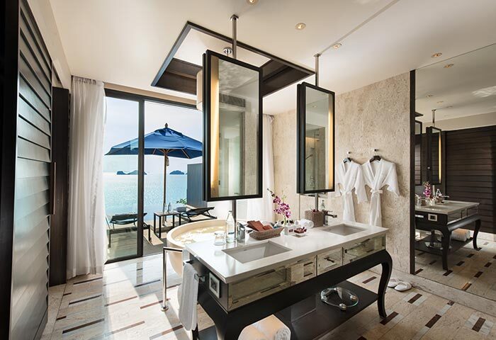 Luxury bathroom at Conrad Koh Samui, a gay-friendly resort. Ocean view, bathtub, and double vanity. Ideal for gay men's travel.