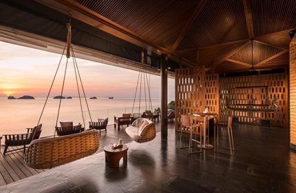 Conrad Koh Samui Resort view. Sunset from a luxury gay-friendly hotel in Thailand. Hanging chairs and ocean views at Conrad-Koh-Samui-Resort.