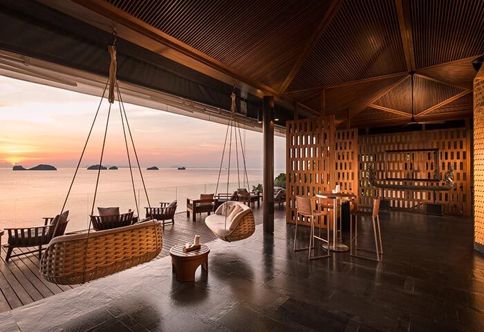 Conrad Koh Samui Resort view. Sunset from a luxury gay-friendly hotel in Thailand. Hanging chairs and ocean views at Conrad-Koh-Samui-Resort.