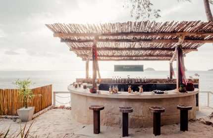 Beach bar at Conrad Koh Samui, Thailand. Tropical gay travel destination with ocean view. Luxury resort for LGBTQ+ travelers.