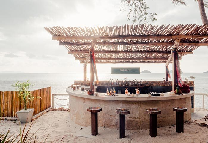 Beach bar at Conrad Koh Samui, Thailand. Tropical gay travel destination with ocean view. Luxury resort for LGBTQ+ travelers.