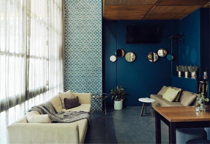 Saint Kilda Beach Hotel's cool design. Gay-friendly Melbourne beachfront hotel lounge area with sofas, mirrors, and stylish decor.