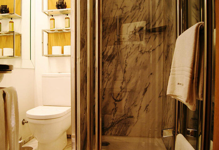 Browns Downtown Hotel Lisbon bathroom. Cool minimalist design at this cheap 3-star gay hotel near gay nightlife. Shower, toilet, shelves.