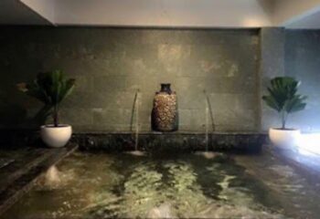 Cool Spa in Ho Chi Minh: Water feature with plants and vase. Gay travel advice for relaxation and wellness in Vietnam's largest city.