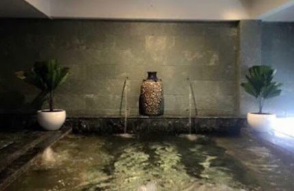 Cool Spa in Ho Chi Minh: Water feature with plants and vase. Gay travel advice for relaxation and wellness in Vietnam's largest city.