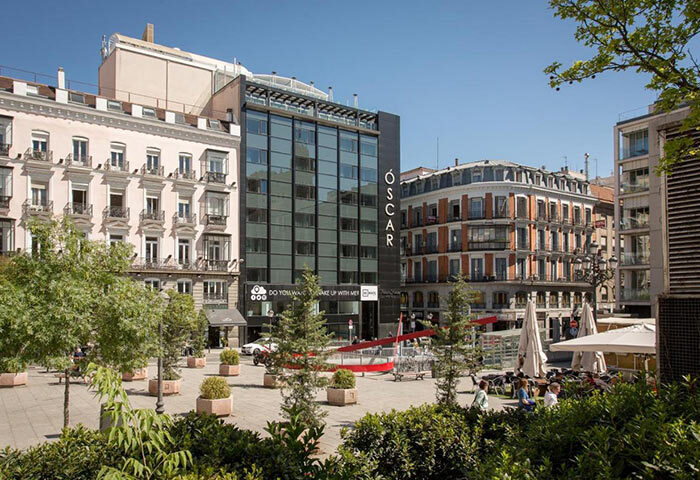 Room Mate Oscar, a cool design boutique hotel in Madrid's gayborhood, Chueca. Modern architecture blends with classic buildings.