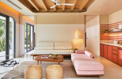 The Standard Hua Hin hotel suite. Coolest gay honeymoon hotel with stylish pink chaise lounge, striped couch, and kitchenette. Beach views.