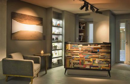 Hôtel Jules & Jim's lobby in Paris. Coolest gay hotel city centre features modern design, unique reception desk, art, and cozy armchair.